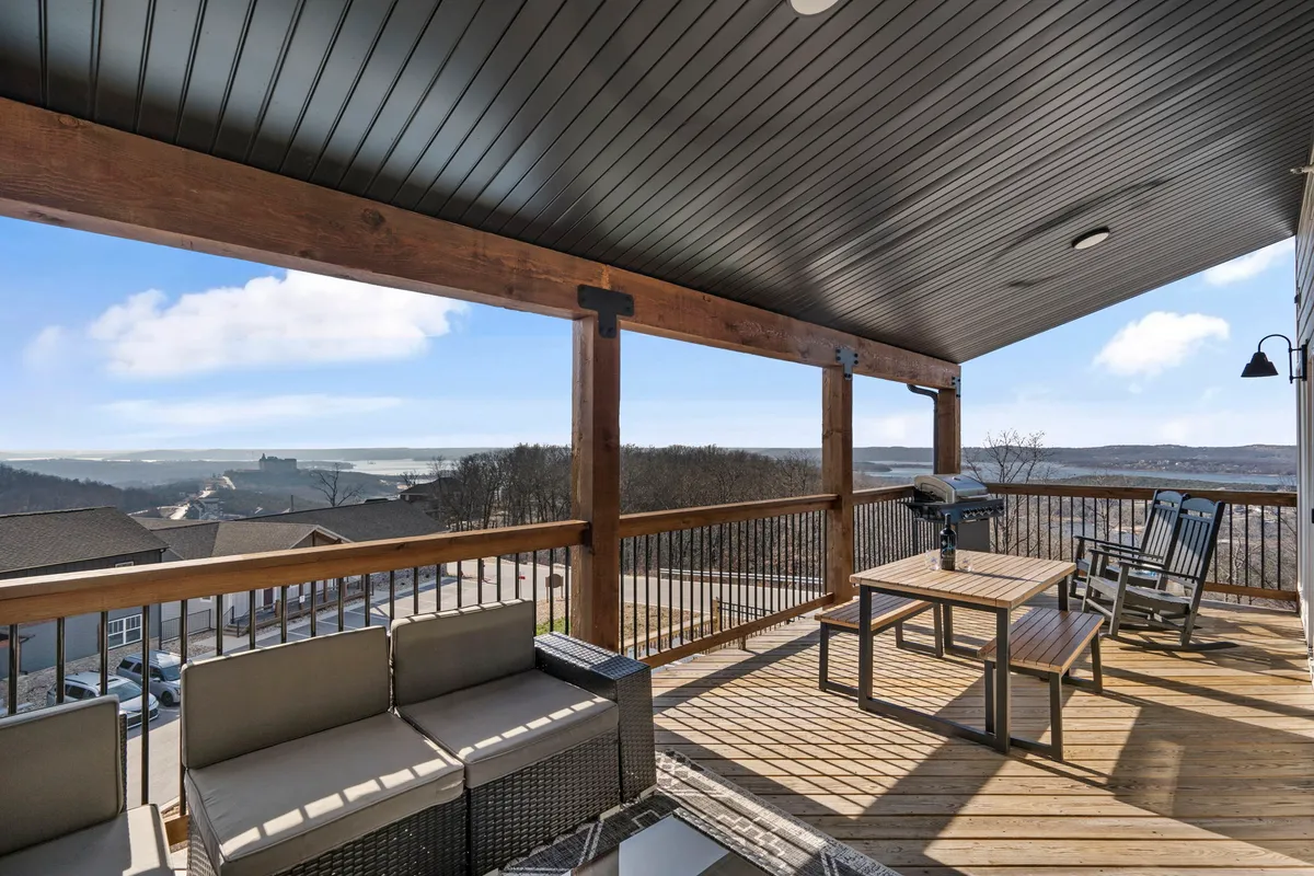 A relaxed outdoor seating area with a grill and a scenic view, perfect for group gatherings. The setup invites guests to enjoy barbecues, shared meals, and conversation while taking in the tranquil surroundings. The setting sun in the background enhances the mood for memorable evenings.
